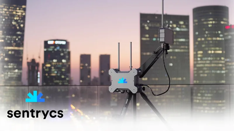 Sentrycs counter-drone sensor on a rooftop above a city skyline at dusk